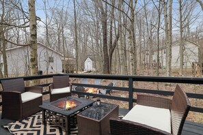 Unwind on the deck patio, where the firepit center table creates the perfect gathering spot. Enjoy cozy evenings with warmth, conversation, and beautiful outdoor vibes.