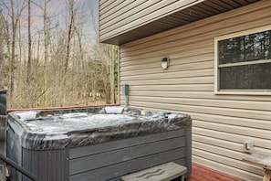 Relax in the private hot tub surrounded by nature.