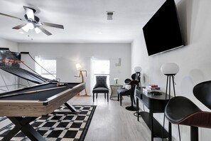 Enjoy endless fun in our game room with a pool table, basketball arcade, and a smart TV for the perfect hangout!
