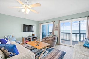Living room with Smart TV and Screened in Balcony overlooking the water