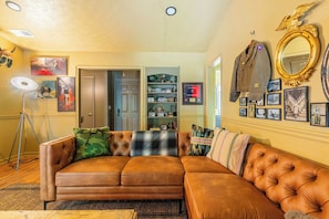 Spacious living room with cozy seating and entertainment options — ideal for relaxing evenings near Fort Moore, GA.