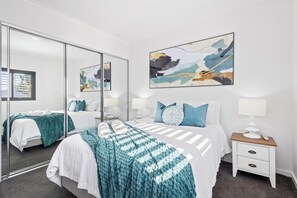 Retreat to a serene and comfortable bedroom, featuring mirrored wardrobes that enhance the sense of space and light.
