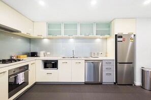 Get prepared for a delicious meal in this well-equipped space, featuring sleek cabinetry, stainless steel appliances, and ample counter space