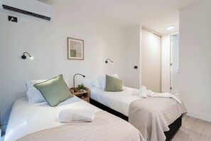 Designed for easy sharing. Our twin bedroom offers comfort and convenience for companions exploring Santiago.