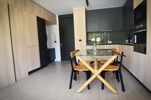 Sleek and modern kitchen with stylish dining area, perfect for enjoying meals in a contemporary setting.