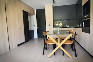 Sleek and modern kitchen with stylish dining area, perfect for enjoying meals in a contemporary setting.
