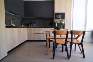 Sleek and modern kitchen with stylish dining area, perfect for enjoying a cozy meal or entertaining guests.