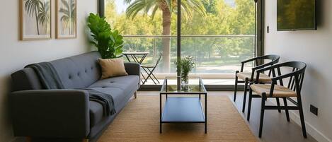 Relax in this stylish living room with stunning views of lush greenery and palm trees, perfect for unwinding after a day of exploring.