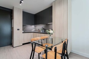Sleek and modern kitchen with stylish dining area, perfect for enjoying meals in comfort.
