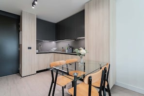 Sleek and modern kitchen with stylish dining area, perfect for enjoying meals in comfort.