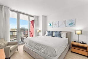 Experience luxury in our master bedroom with a king-sized bed and a connecting balcony offering stunning