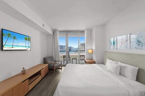 Experience luxury in our master bedroom with a king-sized bed and a connecting balcony offering stunning waterfront views.