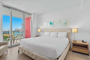 Experience luxury in our master bedroom with a king-sized bed and a connecting balcony offering stunning waterfront views.