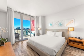 Experience luxury in our master bedroom with a king-sized bed and a connecting balcony offering stunning