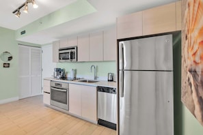 Fully Stocked Kitchen with washer and dryer in unit