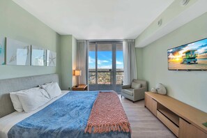Experience luxury in our master bedroom with a king-sized bed and a connecting balcony offering stunning waterfront views.