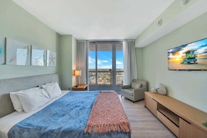 Experience luxury in our master bedroom with a king-sized bed and a connecting balcony offering stunning waterfront views.