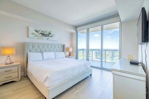 Experience luxury in our master bedroom with a king-sized bed and a connecting balcony offering stunning