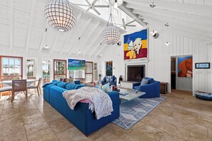 Dive into comfort with our stunning blue couches! Paired with a beautiful painting, this living room is a dream come true.