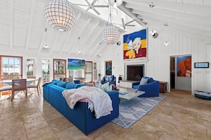 Dive into comfort with our stunning blue couches! Paired with a beautiful painting, this living room is a dream come true.