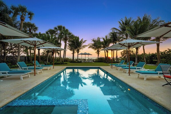 Our stunning pool awaits you, complete with cozy lounge chairs and umbrellas to soak up that sunset magic. Who's ready for a getaway?