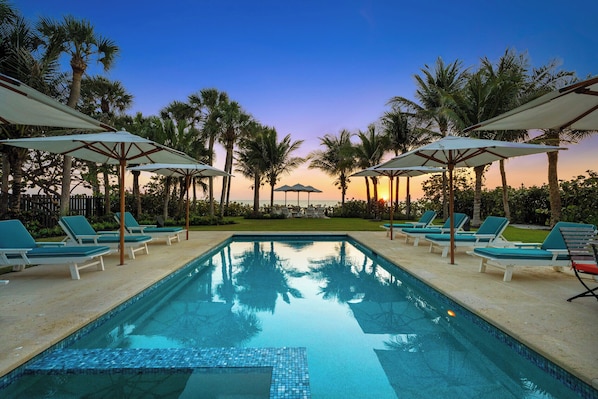 Our stunning pool awaits you, complete with cozy lounge chairs and umbrellas to soak up that sunset magic. Who's ready for a getaway?