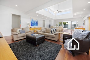 Main open plan living area, with kitchen and dining in background
