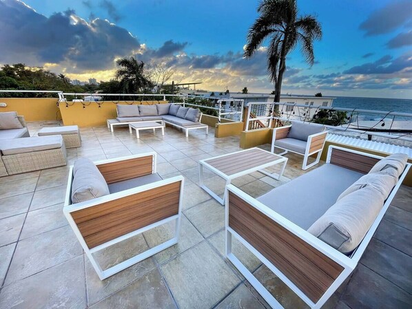 Shared rooftop with lounge chairs and an ocean view (1)