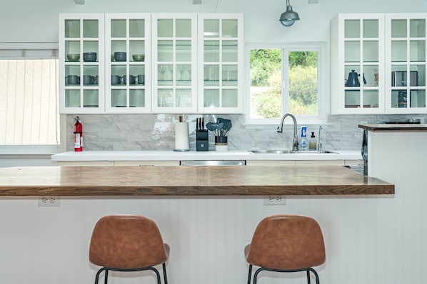 Large kitchen island for gathering and cooking. Fully-stocked kitchen.