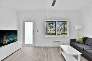 Bright living area with outdoor view and large Tv in Boca Raton