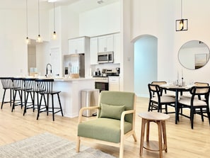 The living room is connected to the equipped kitchen and dining space