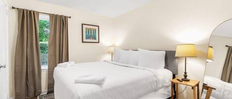 Minimalist Bedroom with bedside lamp and mirror