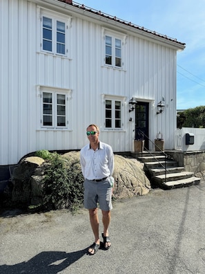 Owner in front of house