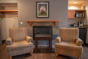 Take a seat in front of the fireplace and enjoy the living area.