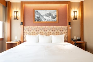 Get a sumptuous night sleep on the plush king-sized bed in this beautiful mountain room.