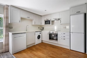 Sleek white kitchen with modern appliances and a welcoming feel.