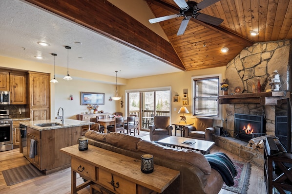 The main floor's open layout blends the living room, dining area, and gourmet kitchen, creating a seamless space for your group to cook, relax, and socialize. A wood-burning fireplace, cozy seating, and mountain-inspired décor set the perfect atmosphere for après-ski relaxation or enjoying your morning coffee together.