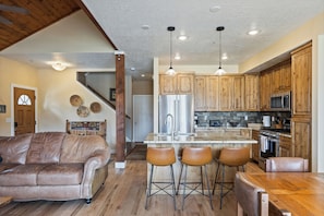 The gourmet kitchen features granite countertops, stainless steel appliances, and all the essentials for cooking.