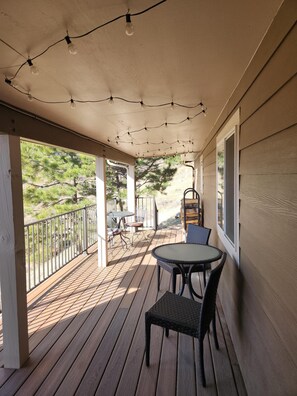 Quaint covered patio for watching the wildlife while sipping on your morning coffee.