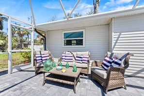 Patio lounge with table, chairs and loveseats.  Ready and waiting for your Happy Hour!.