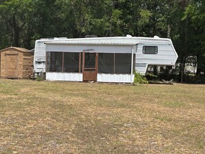 Vintage 36’ RV for guests with screened patio
