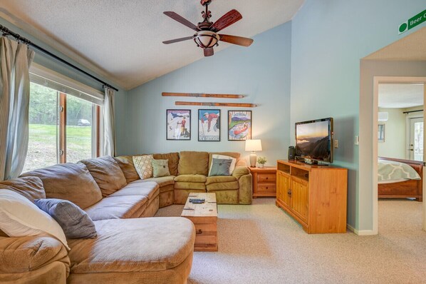 Open den area with A/C, plush sectional and a TV with streaming services—perfect for relaxing nights in.