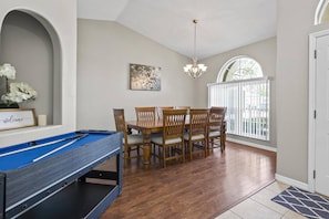 Welcoming entryway into La Playa Pool Home featuring a mini pool table and a front dining room perfect for gathering and games.