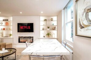 As you enter, your eyes will be drawn to the impressive art piece and a shelf adorned with house plants to give that natural ambience