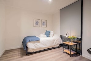Cozy bedroom with modern decor and a serene ambiance, perfect for a restful night's sleep.