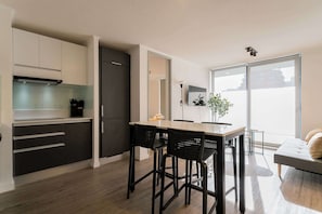 Sleek and modern kitchen with ample natural light, perfect for cozy meals and relaxation.
