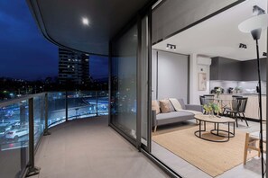 Enjoy stunning city views from this modern apartment's spacious balcony, perfect for relaxing evenings or entertaining guests.