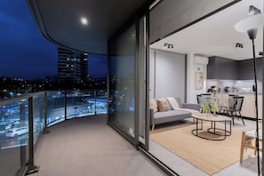 Enjoy stunning city views from this modern apartment's spacious balcony, perfect for relaxing evenings or entertaining guests.