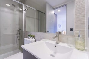Experience modern elegance in this sleek bathroom, complete with a glass shower and stylish decor.