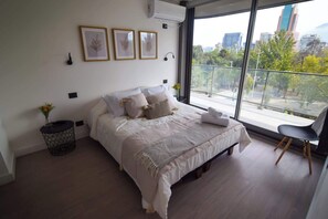 Enjoy a cozy stay in this modern bedroom with stunning views and stylish decor, perfect for relaxation after a day of exploring.